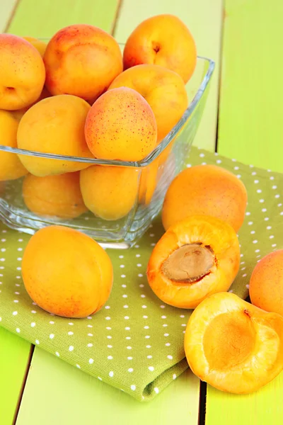 Fresh natural apricot in bowl on green wooden table — Stock Photo, Image