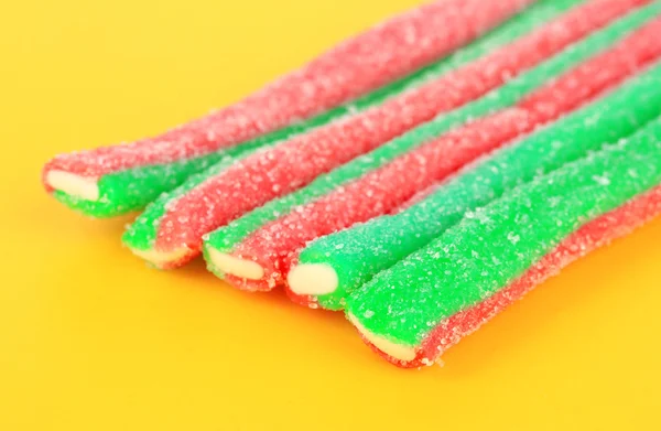 Sweet jelly candies on yellow backgroun — Stock Photo, Image