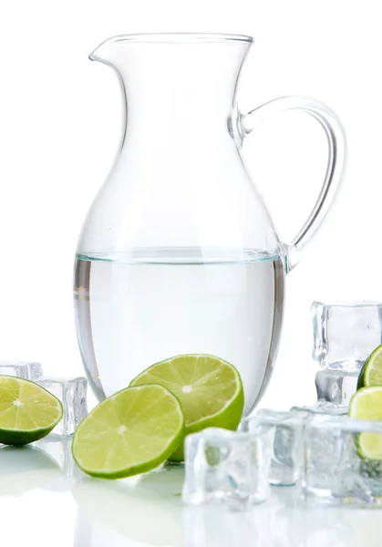 Glass pitcher of water with ice and lime isolated on white — Stock Photo, Image