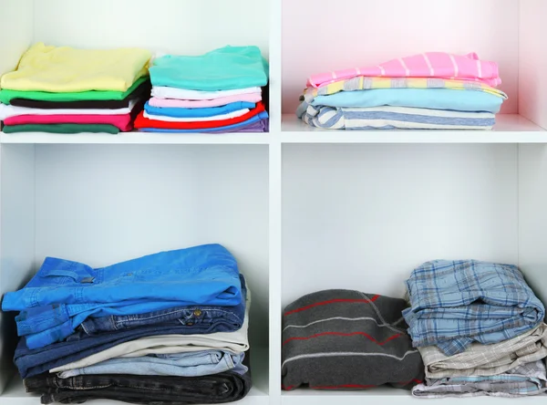 Clothes neatly folded on shelves — Stock Photo, Image