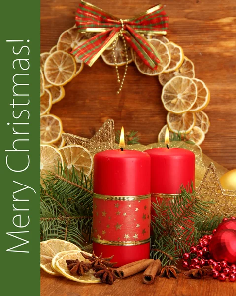 Two candles and Christmas decorations, on wooden background — Stock Photo, Image
