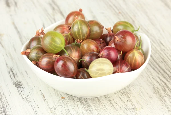Fresh gooseberries in bowl on table close-up Royalty Free Stock Images