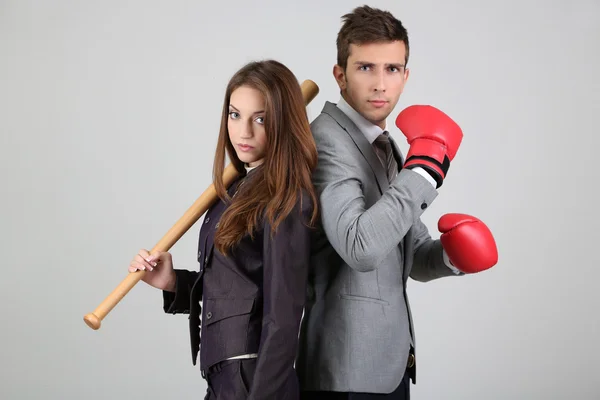 Armed young business people on grey background — Stock Photo, Image