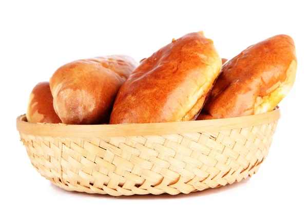 Fresh baked pasties in wicker basket, isolated on white — Stock Photo, Image