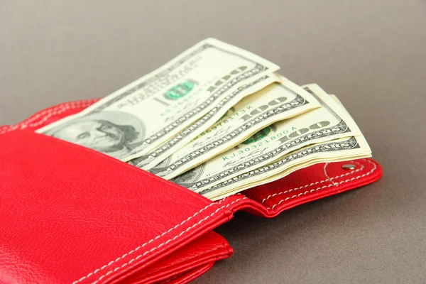 Purse with hundred dollar banknotes, on color background — Stock Photo, Image