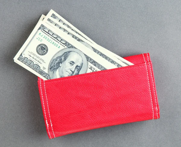 Purse with hundred dollar banknotes, on color background — Stock Photo, Image