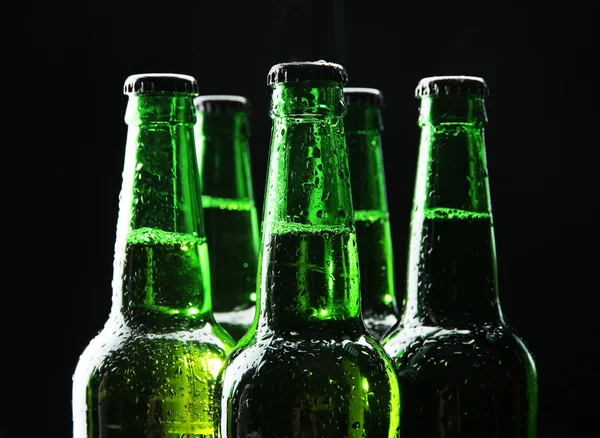 Бутылки пива на черном фоне — стоковое фото