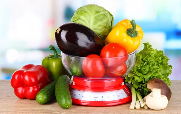 Fresh vegetables in scales on table in kitchen — Stock Photo, Image