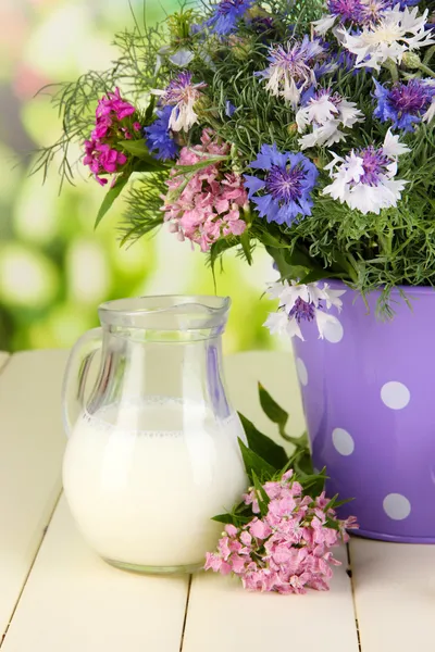 Beautiful bouquet in pail on wooden table on natural background — Stock Photo, Image