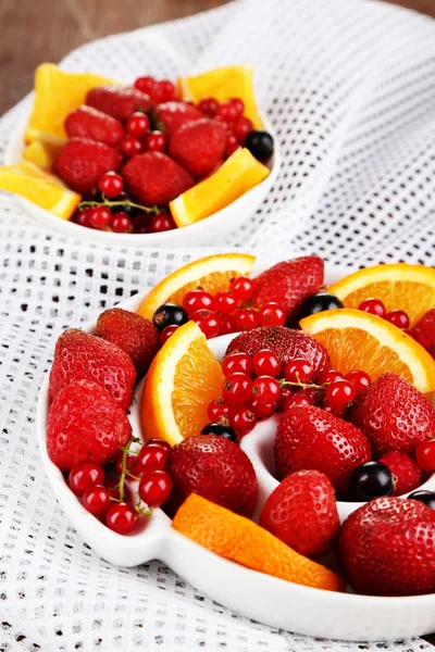 Useful fruit salad in plates on wooden table close-up — Stock Photo, Image