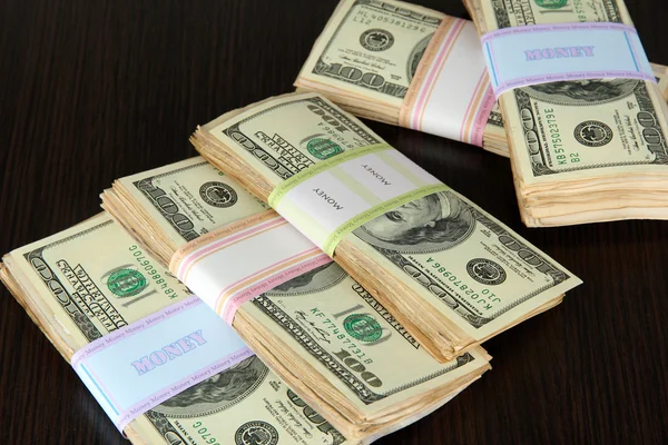 Stacks of money on wooden table — Stock Photo, Image