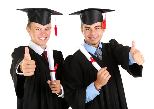 Dois estudantes graduados felizes isolados em branco Imagens Royalty-Free