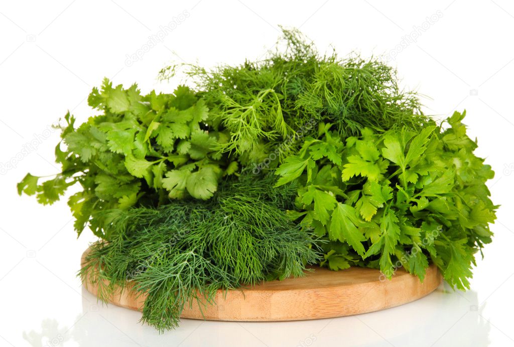 Useful herbs on wooden cutting board isolated on white