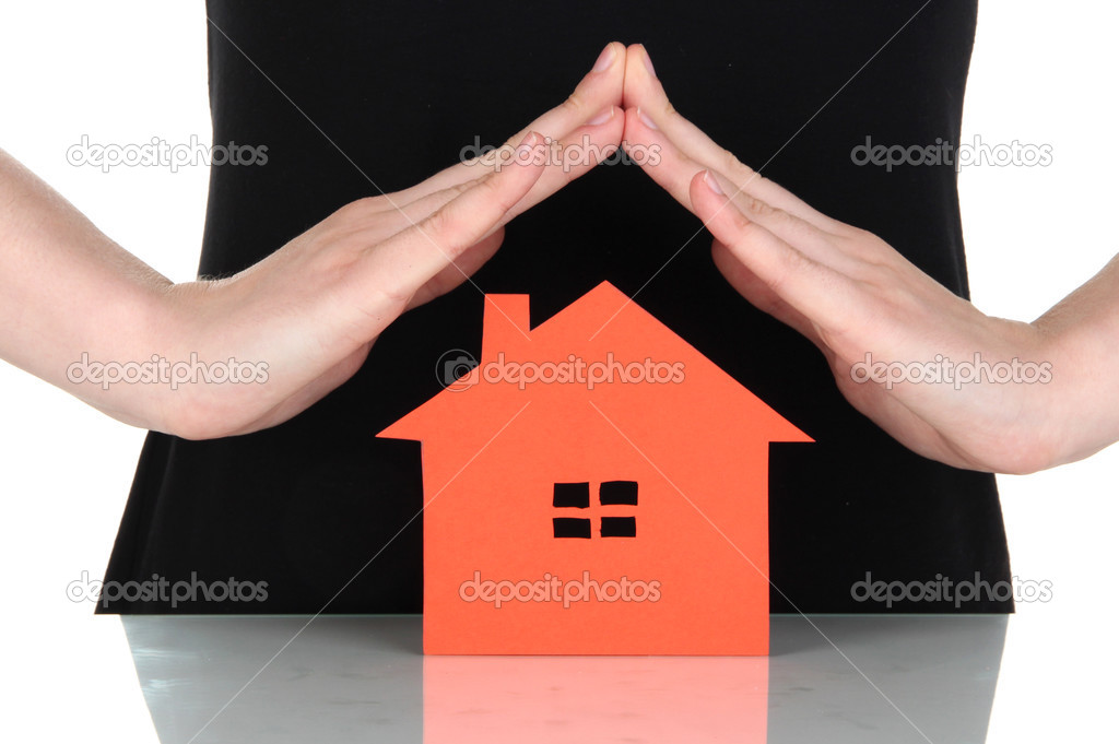 Paper house in hands isolated on white