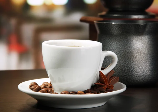 Cup of coffee, grinder, turk and coffee beans in cafe — Stock Photo, Image