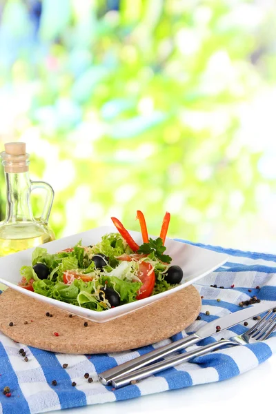 Leichter Salat auf Teller auf Serviette auf Fensterhintergrund — Stockfoto