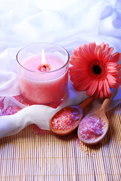 Beautiful candle with flower on white cloth, close up — Stock Photo, Image