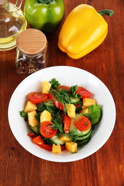 Light salad in plate on wooden table Royalty Free Stock Photos