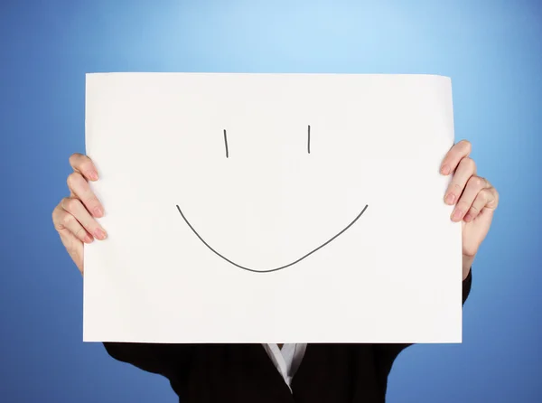 Woman holding paper with smile, on color background — Stock Photo, Image