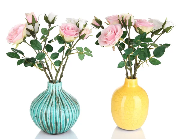 Schöne rosa und weiße Rosen in Vasen isoliert auf weiß — Stockfoto