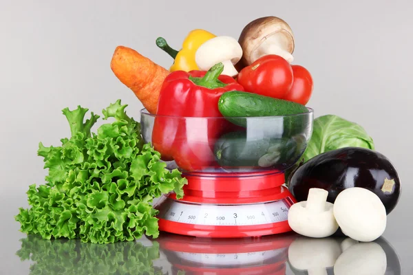 Fresh vegetables in scales on gray background — Stock Photo, Image