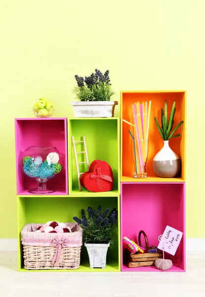 Shelves of different bright colors with decorative addition on wall background — Stock Photo, Image