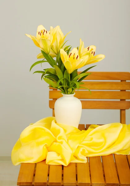 Beautiful orange lilies in vase on wooden table Stock Image