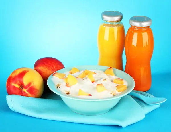 Tasty dieting food and bottles of juice, on blue background — Stock Photo, Image