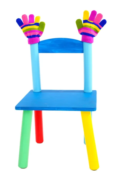 Small and colorful chair with baby mittens isolated on white — Stock Photo, Image