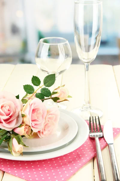 Table serving on a wooden background on the background of the room — Stock Photo, Image