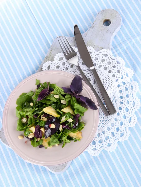 Light salad on plate on napkin — Stock Photo, Image