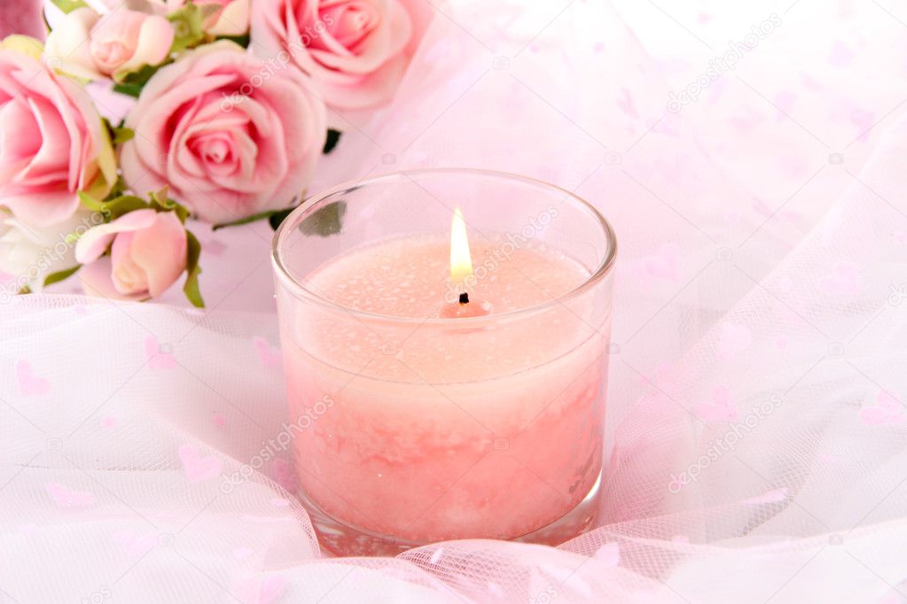 Beautiful candle with flowers on white cloth, close up — Stock Photo