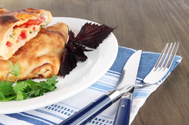 Pizza calzone peçete ahşap masa üzerinde plaka üzerinde