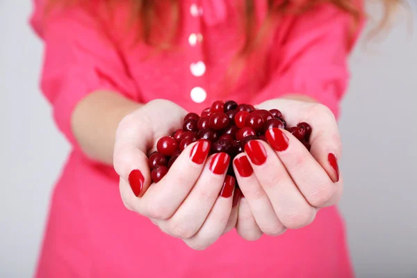 Woman hands holding ripe red cranberries, close u — Stock Photo, Image