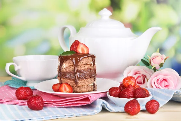 Chocolate cake met aardbei op houten tafel op natuurlijke achtergrond — Stockfoto