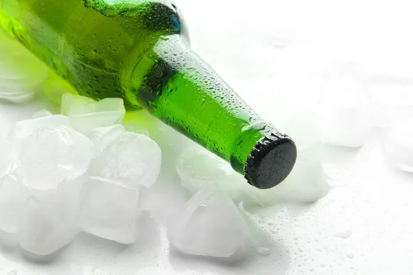 Bottle of beer with ice cubes, close up — Stock Photo, Image