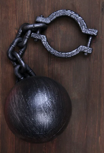 Ball and chain on wooden background — Stock Photo, Image