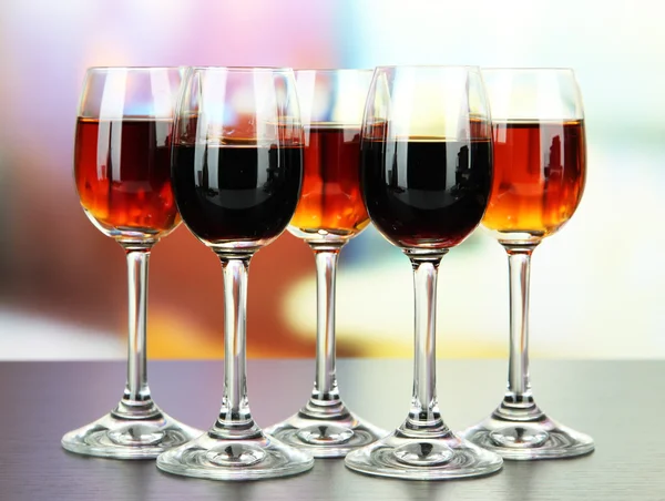 Glasses of liquors, on bright background — Stock Photo, Image