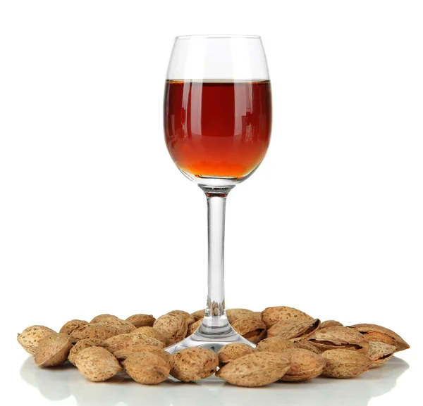 Glass of amaretto liquor and roasted almonds, isolated on white Stock Image