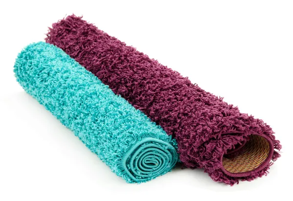 Twee warmgewalste tapijten geïsoleerd op wit — Stockfoto