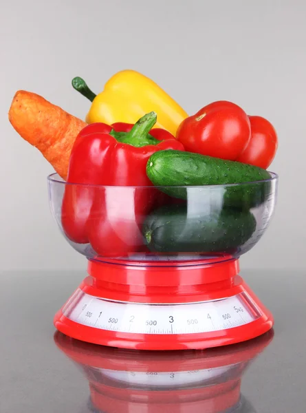 Fresh vegetables in scales on gray background — Stock Photo, Image