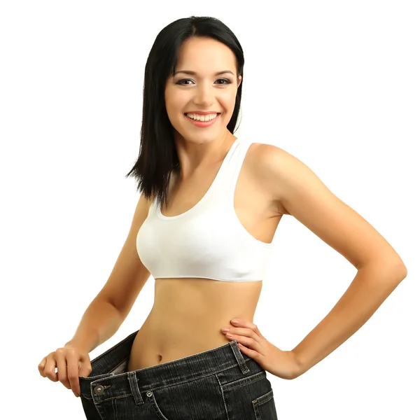 Belle jeune femme avec de gros jeans isolés sur blanc — Photo