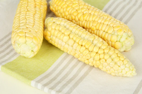 Fresh corn on napkin, on wooden background — Stock Photo, Image