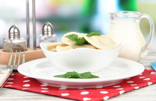 Tasty dumplings on white plate, on bright background — Stock Photo, Image