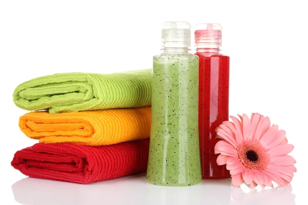 Colorful towels and cosmetics bottles, isolated on white — Stock Photo, Image