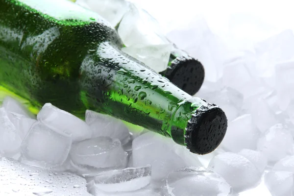 Bottles of beer with ice cubes, close up — Stock Photo, Image