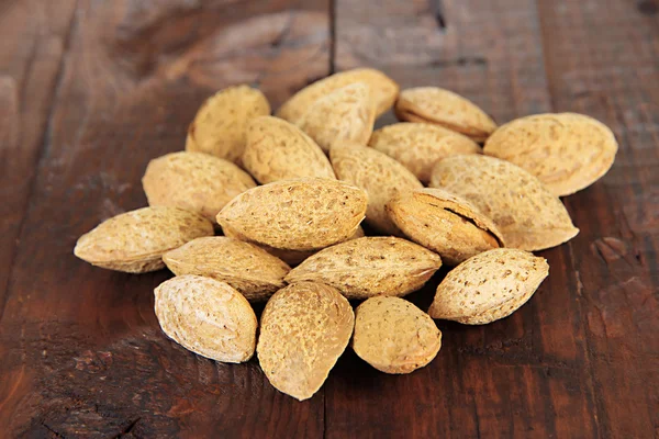 Almond on dark wooden background — Stock Photo, Image