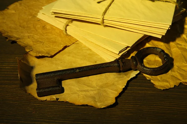 Antique key and letters on dark background — Stock Photo, Image