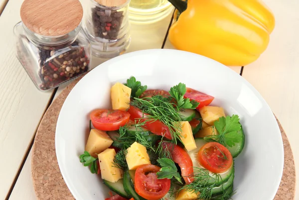 Light salad in plate on wooden table — Stock Photo, Image