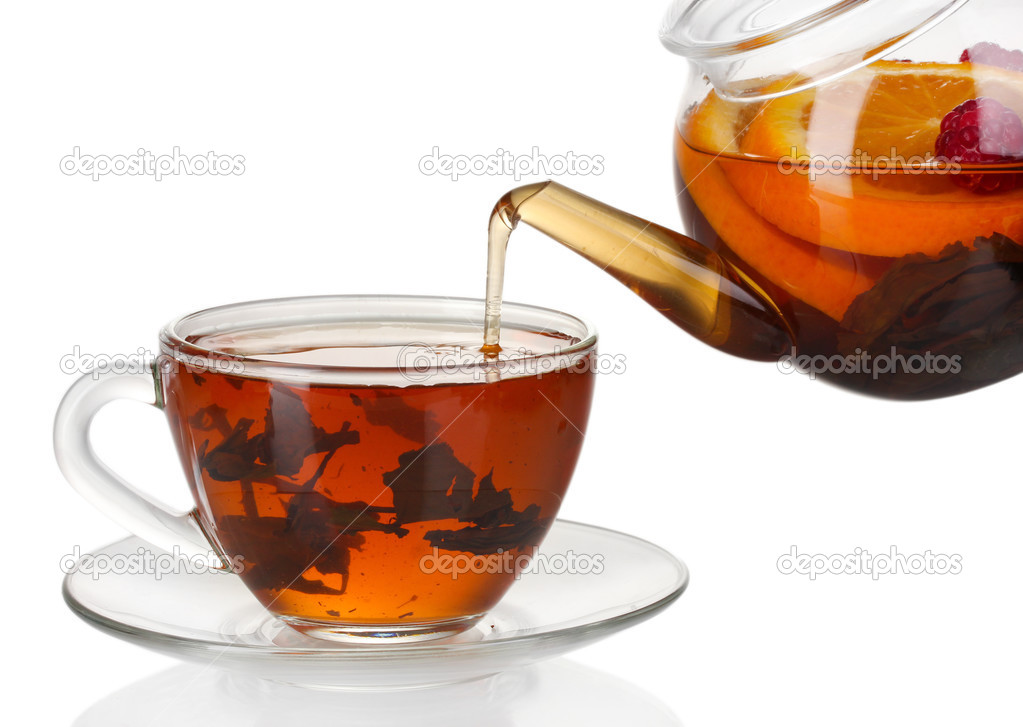 Glass teapot pouring black tea into cup isolated on white — Stock Photo